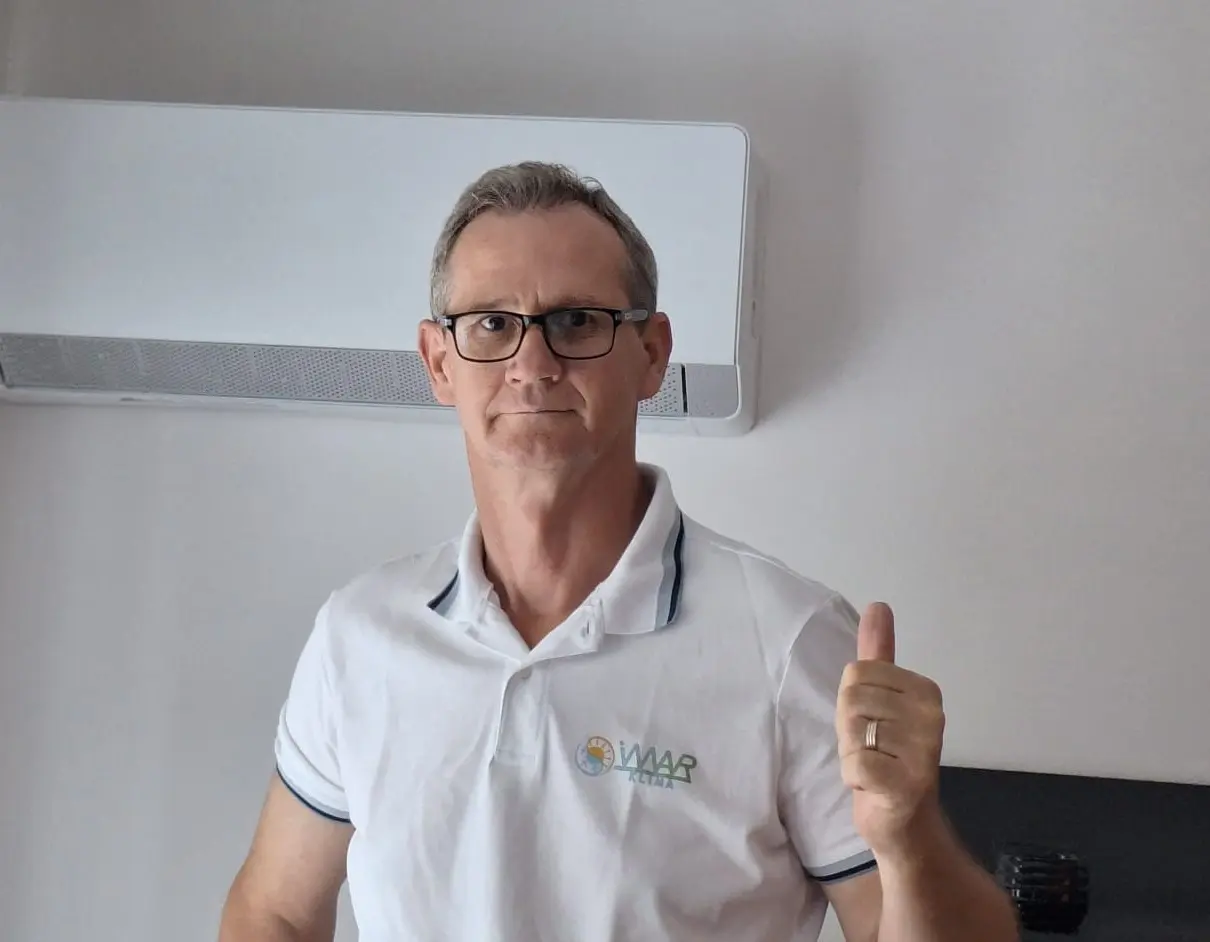 Spokojný muž stojaci pred klimatizáciou